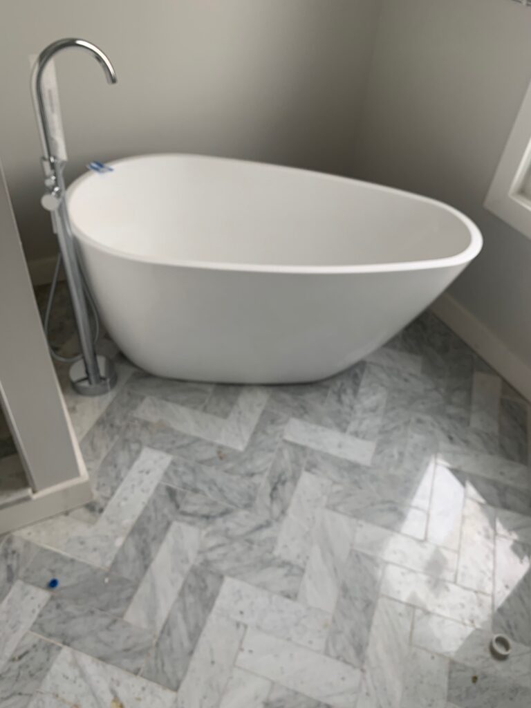 Jacuzzi bath remodel in a modern New Jersey home with clean white tiles and built-in spa tub