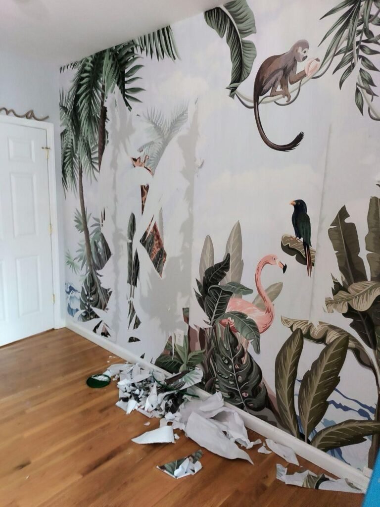 Technician removing wallpaper.